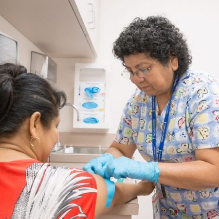 SpanishCatholicCenter A nurse gives medical care to a patient at the Spanish Catholic Center; CCADW; Catholic Charities
